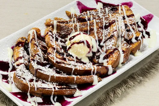 Crunchberry French Toast — Texas toast rolled in Crunchberry cereal with blueberry jelly, cream cheese icing and powdered sugar